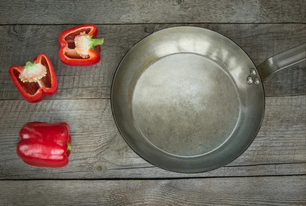 Red Paprika and pan on vintage wooden board. Top view with copy space. — Stock Photo, Image