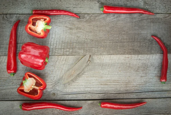 Red Hot Chili Peppers and paprika on vintage wooden. Top view with copy space.