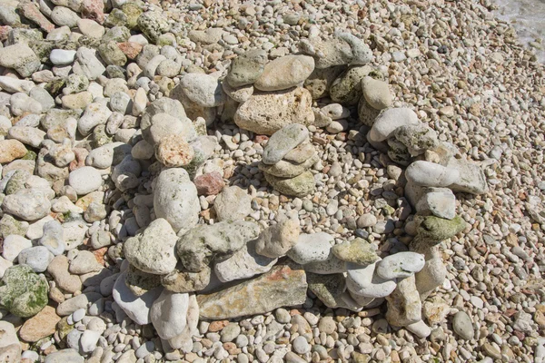 Textura kamenů na pláži pro pozadí — Stock fotografie