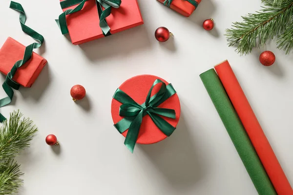 グレーの赤と緑の紙にクリスマスの贈り物を包む クリスマス休暇の準備 トップ表示 — ストック写真