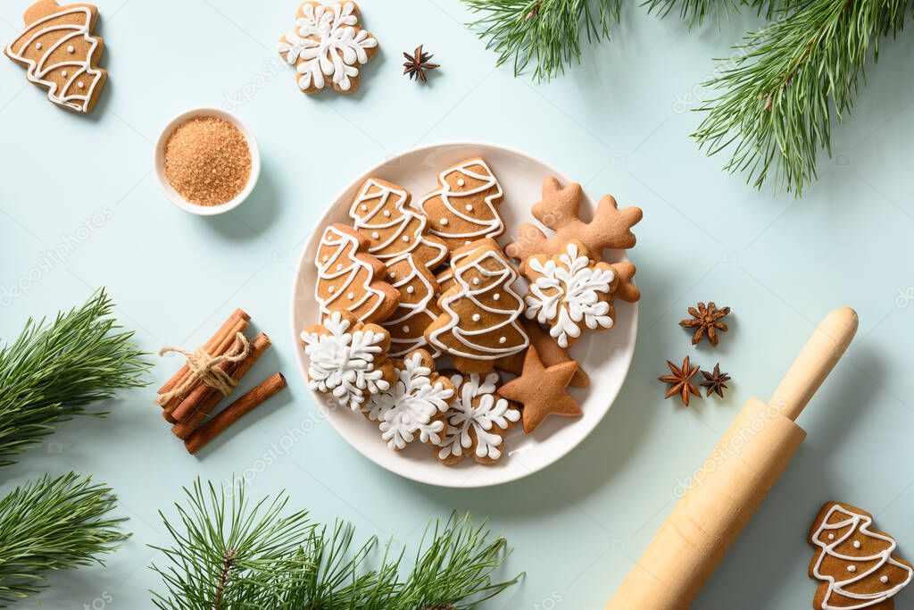 Christmas gingerbread cookies on light background. Merry Christmas and Happy New Year greeting card. Flat lay style.