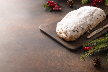 Christmas traditional stollen on brown background. Copy space. Close up. clipart