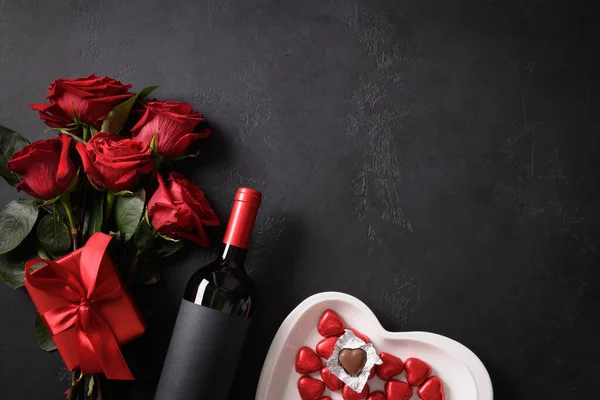 情人节送巧克力糖果、红玫瑰和红葡萄酒，并配以黑色礼物. — 图库照片