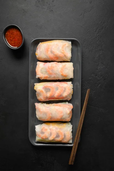 Asian spring rolls with prawn with spicy sauce wrapped in rice paper.