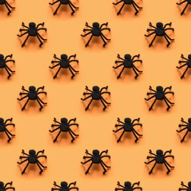 Turuncu arka planda siyah örümceklerin kusursuz deseni. Cadılar Bayramı deseni.