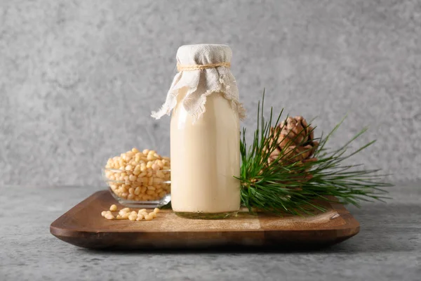 Leche de cedro vegano sobre fondo gris. Leche alternativa no láctea. —  Fotos de Stock