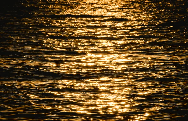Sea wave on yellow color at sunset time — Stock Photo, Image