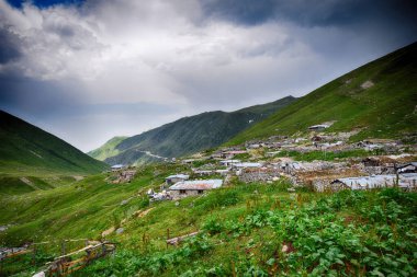 Avusor Platosu ve Kackar Dağları mavi bulutlu gökyüzü arka planına sahip. İskoçya ve eski evler