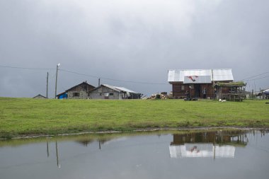 Rize, Turkey - August 16 2017 : Aerial view of Badara Plateau and its traditional houses. Landscape photo was taken in summer. Pond and wonderful nature view on the plateau