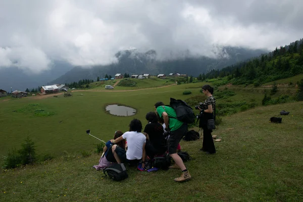 Rize, Turkey - August 16, 2017 : A group of photographers at the plateau summit. Aerial view of Badara Plateau and its traditional houses.