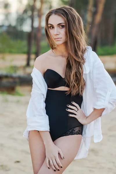 Beautiful young brunette woman in black lingerie and white shirt — Stock Photo, Image