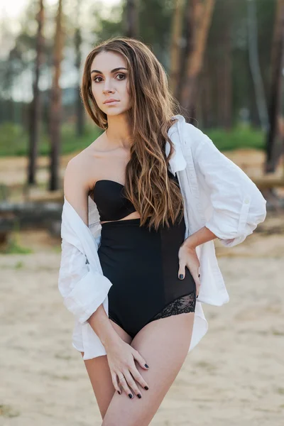 Beautiful young brunette woman in black lingerie and white shirt — Stock Photo, Image