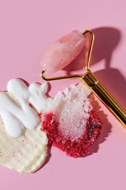 Çeşitli kozmetik maskeler, kremler, serum, fırça ve losyon lekeleri pembe arka planda. Güzellik dokusu. Kozmetik ürün örneği.