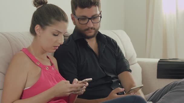Пара просматривает Интернет на мобильных телефонах — стоковое видео