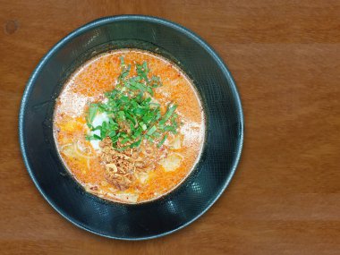 Manzaralı Kuay Japon Yuan Tom Yum sebzeli, domuz sosisli ve siyah seramik kaseli ahşap zemin zeminli, yiyecek, nesne, lezzetli, lezzetli, kopyalama alanı