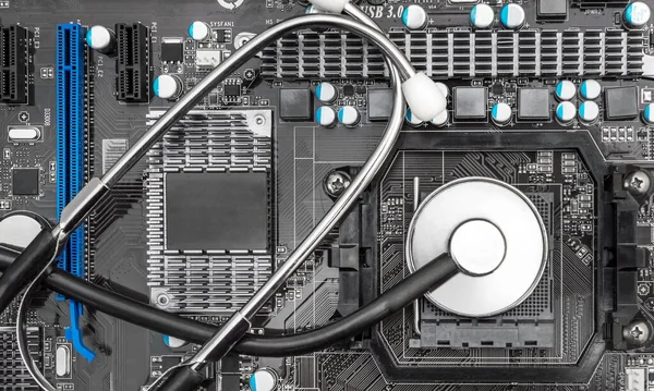 Computer diagnostics concept. Stethoscope on motherboard. Top view.