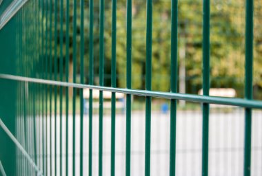 Yeşil renkte boyalı metal çit teli