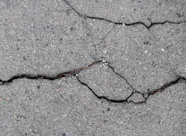 Popraskaný asfaltový povrch textury pozadí — Stock fotografie