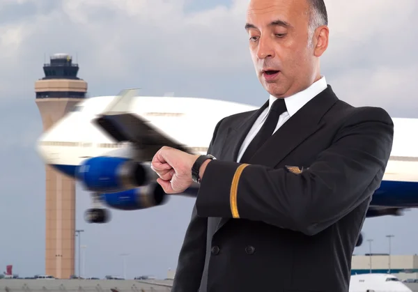 Handsome airline worker looking at his watch — Stock Photo, Image