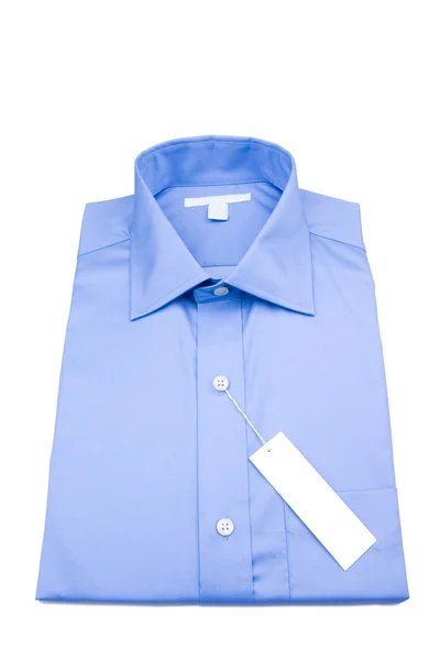 Camisa dobrada com etiqueta branca — Fotografia de Stock