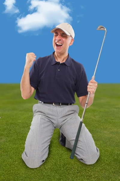Golf player on knees with club in hand on golf green