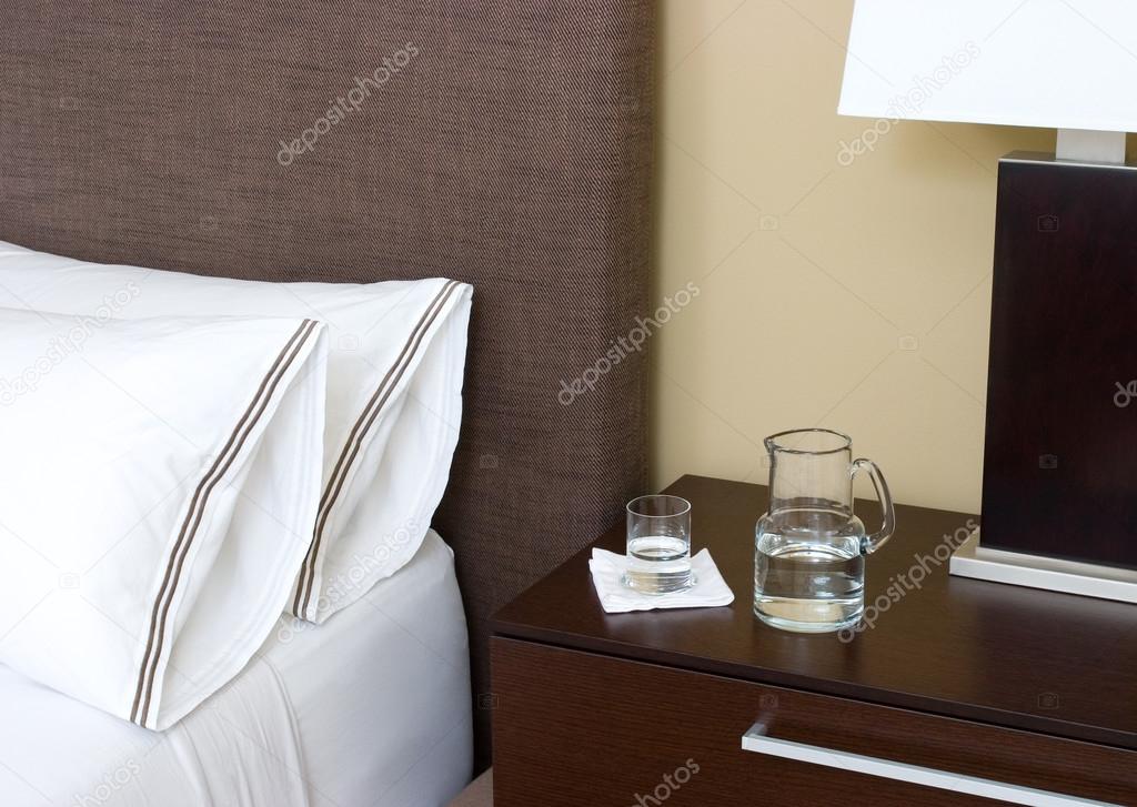 Water pitcher and glass on night stand