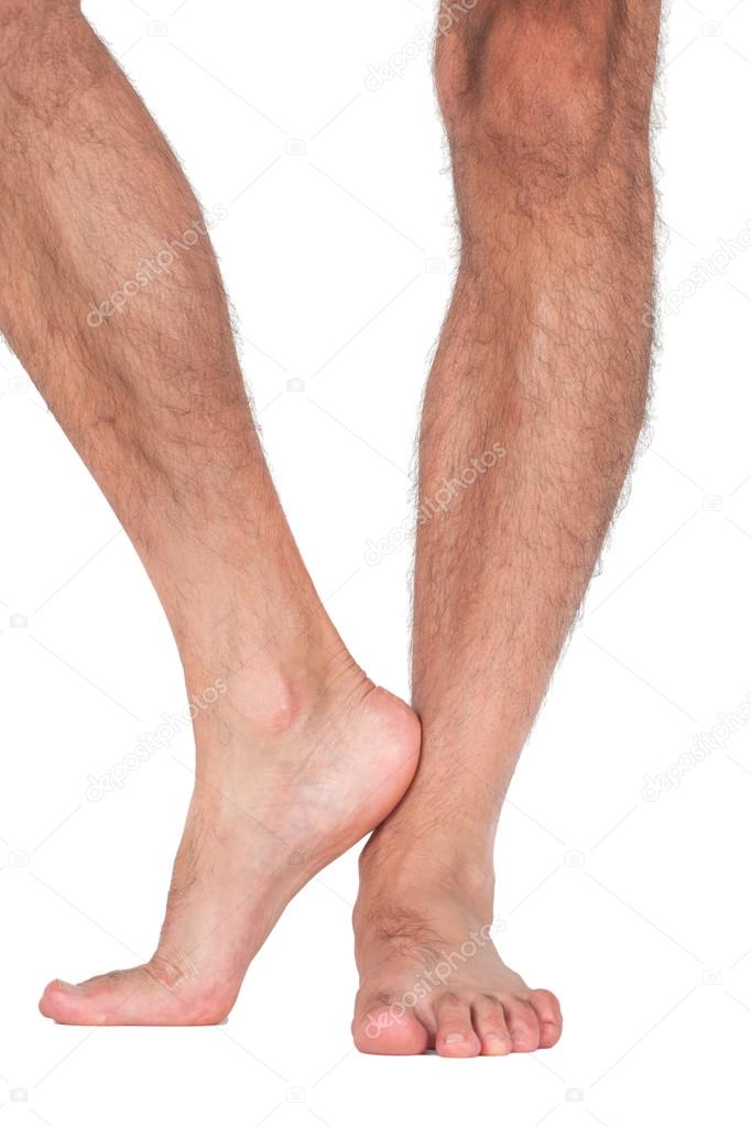 Nude man's legs isolated on white background