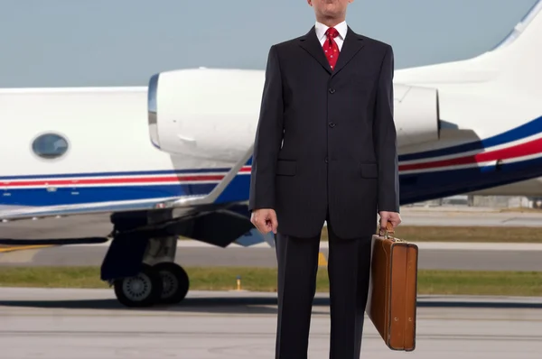 Homme d'affaires debout devant jet d'entreprise — Photo