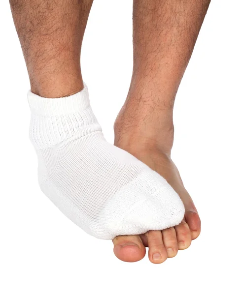 Man's foot with sock covers the other foot — Stock Photo, Image