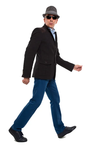 Casual man walking wearing a hat Stock Image