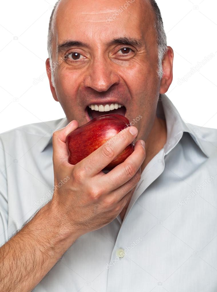 Handsome man eating an apple Stock Photo by ©carlosyudica 91019900