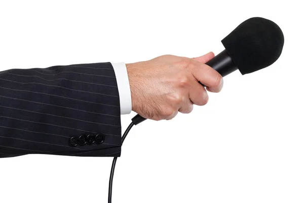 Рука человека держит микрофон — стоковое фото