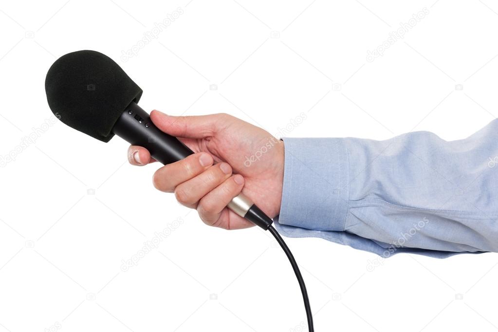 Person's hand holding a microphone