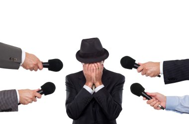 Man being interviewed sorrounded by reporters clipart