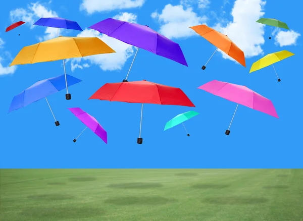 Colorful umbrellas falling from the sky — Stock Photo, Image