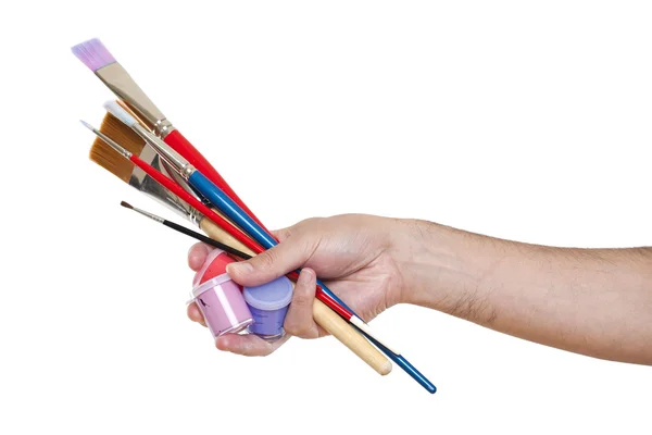 Hand holding several brushes and paint — Stock Photo, Image