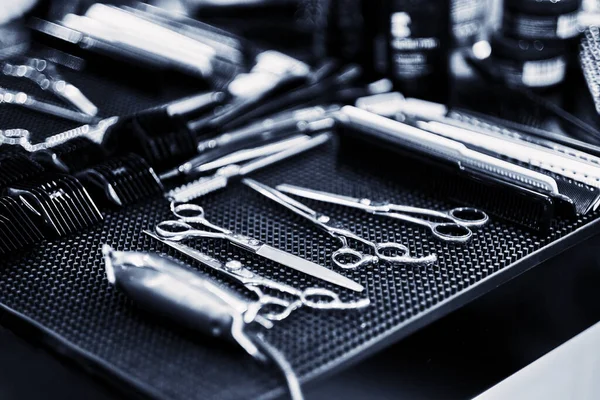 Professional tools of hairdresser in red case. Tools for cutting beard and hair barbershop.