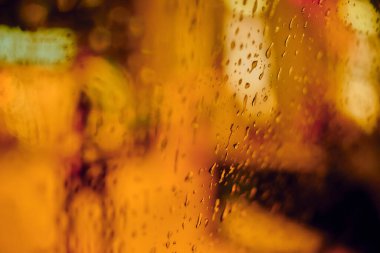 Gece lambasının yağmur damlalı soyut dairesel bokeh arkaplanı