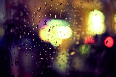 Gece lambasının yağmur damlalı soyut dairesel bokeh arkaplanı