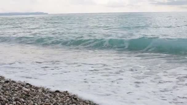 Vue panoramique sur la mer depuis la plage en journée, plage de galets, mer bleue, vagues moussantes — Video