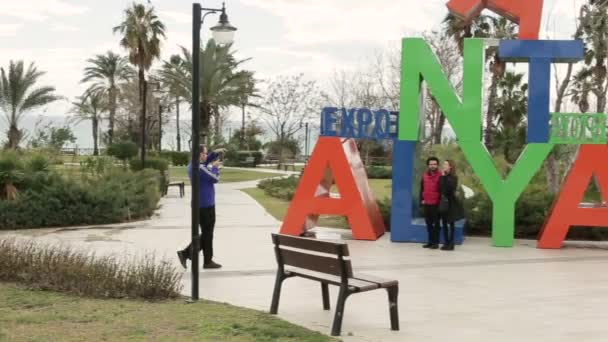 Turkey, Antalya, March 2016, the man photographs a married couple on a smartphone — Stock Video