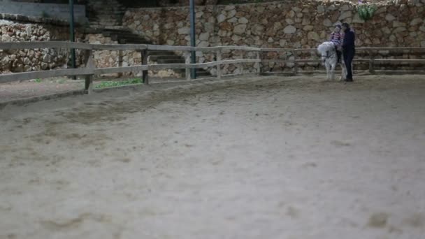 Antalya, Turkey - March 2016: instructor teaches girl to ride a pony — Stock Video