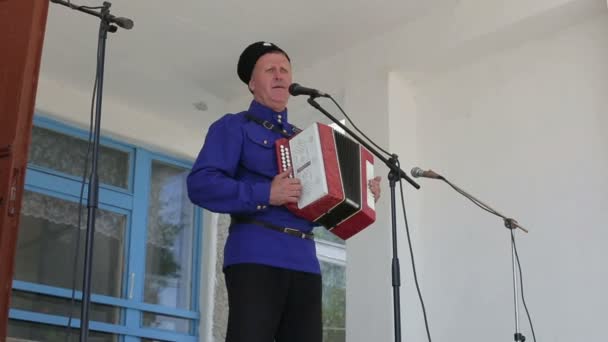 Kurgan, Federacja Rosyjska - maj 2016: Mężczyzn w strojach ludowych rosyjskiej Śpiewaj do mikrofonu i gra na akordeonie — Wideo stockowe