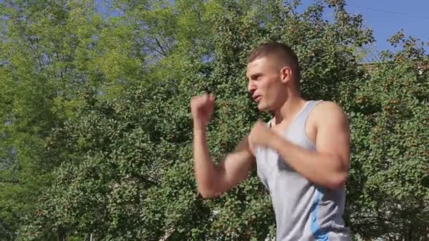 Athletic man exercising outdoors, boxing — Stock Video