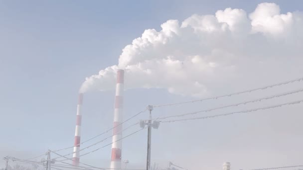 White smoke from industrial chimney on a light background of blue sky. — Stock Footage White smoke from industrial chimney on a light background of blue sky. Royalty Free Stock Footage