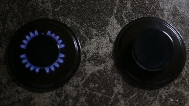 A closeup shot of two gas burners in a line disposed on the stove . Top view composition. — Stock Video