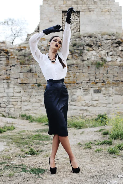 Elegant brunette wears white shirt, leather skirt and gloves — Stock Photo, Image