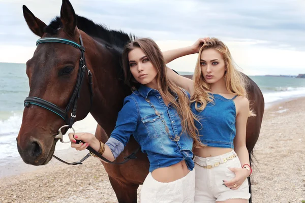Belas mulheres jovens com cavalo preto — Fotografia de Stock