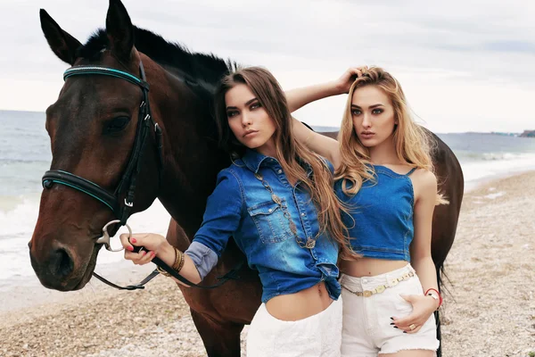 Belas mulheres jovens com cavalo preto — Fotografia de Stock