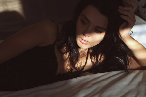 Woman lying in bed in the morning — Stock Photo, Image